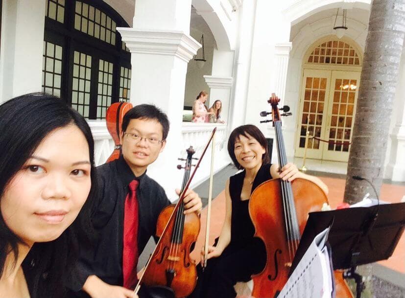 Elaine and three musicians with violins and a viola before a concert