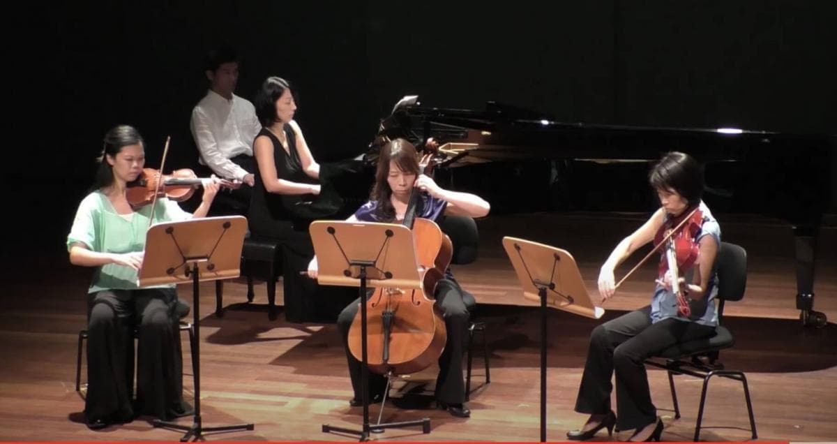 String ensemble rehearsing together with music stands