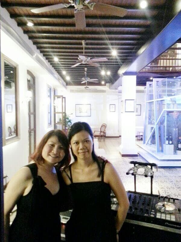 Elaine with a fellow musician in a gallery corridor before performing