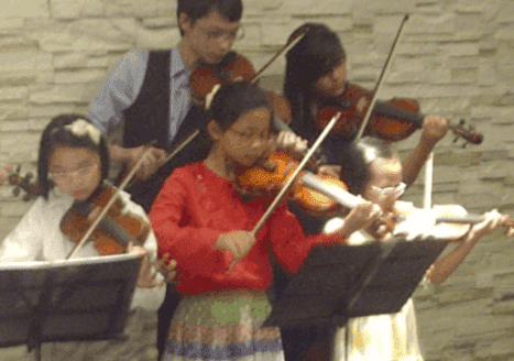 Elaine’s violin students performing at a studio concert in Singapore